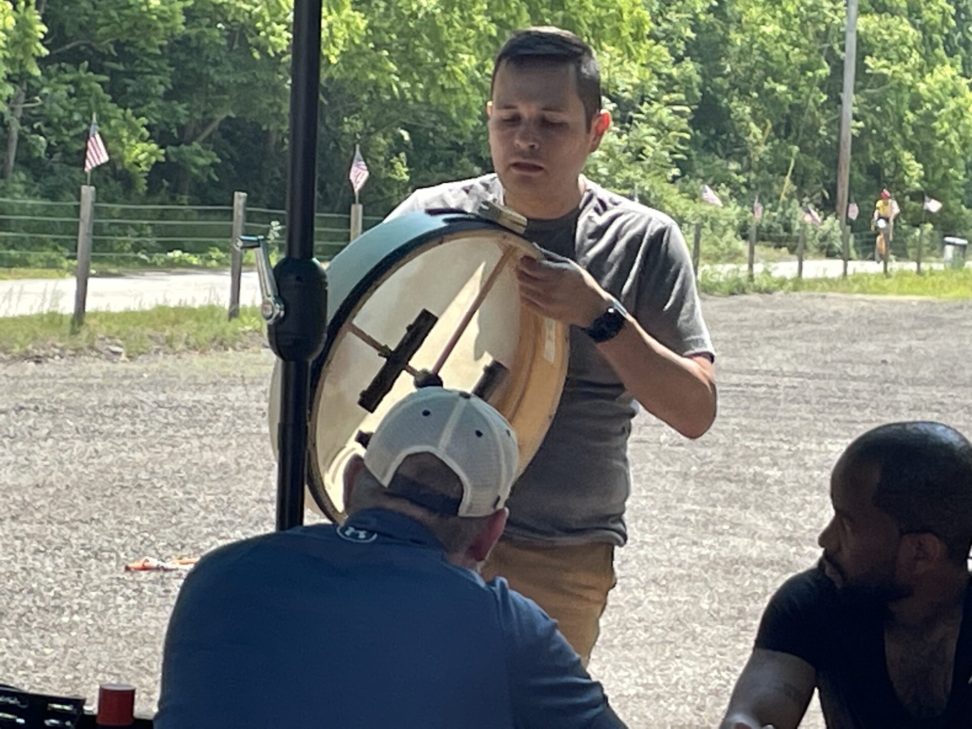 man holding large drum outside