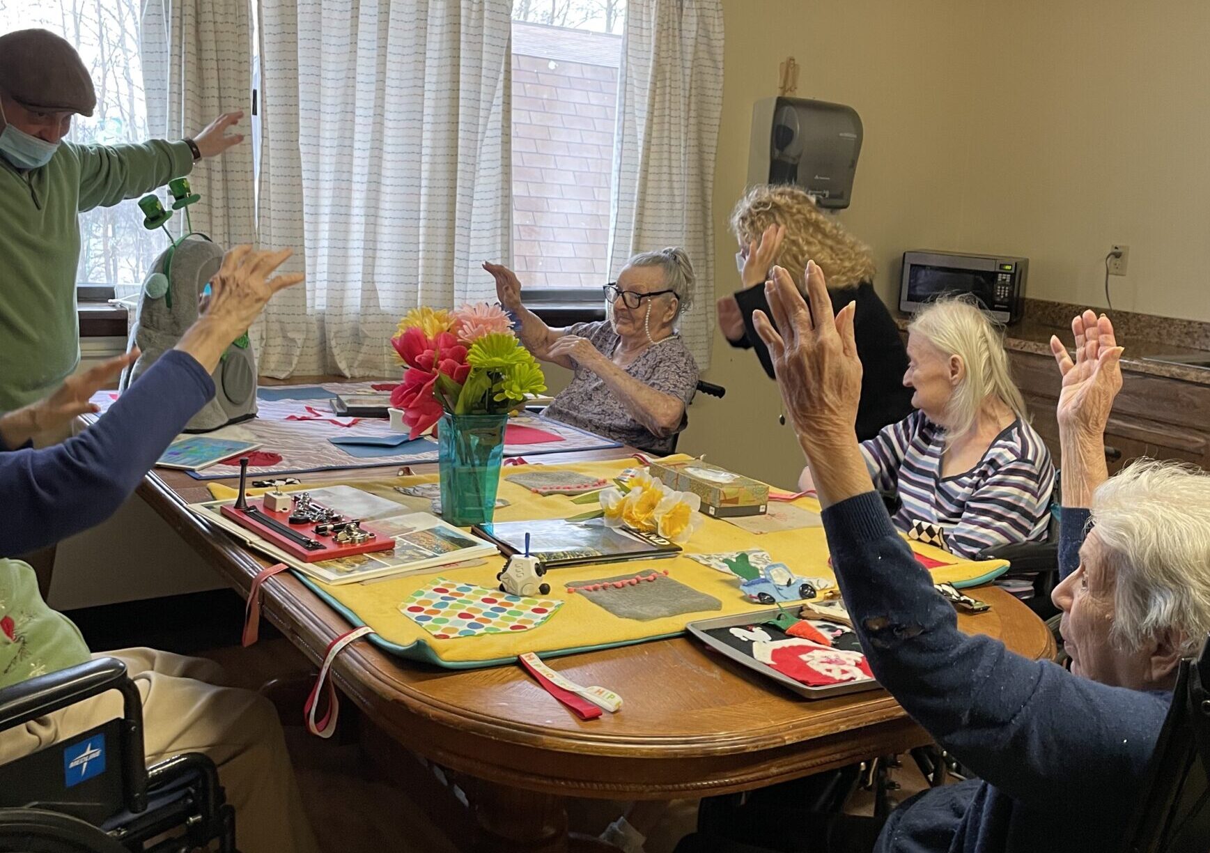 group of people seated around table doing sensory exercises